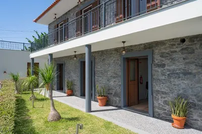 a facade of a house with potted plants at Casa de Pedra by An Island Apart in Ribeira Brava