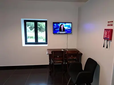 a bedroom with a bed with two tables and two lamps at Casa da Marica in São Vicente