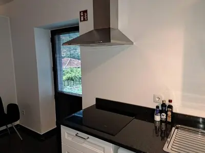a kitchen with a washing machine and a sink at Casa da Vicencia in São Vicente