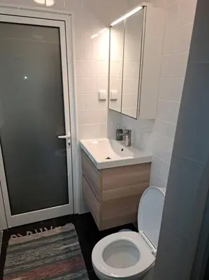 a bedroom with white cabinets and a desk and a bed at Casa da Vicencia in São Vicente