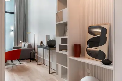 a living room with a tv on a shelf at Savoy Insular Loft by An Island Apart in Funchal