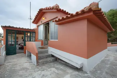 a small house with stairs leading to a door at Luci's House in São Jorge