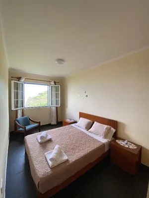 a bedroom with a bed with two towels on it at Ocean Guest House in São Vicente