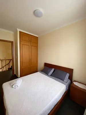a bedroom with a large bed with a white mattress at Ocean Guest House in São Vicente