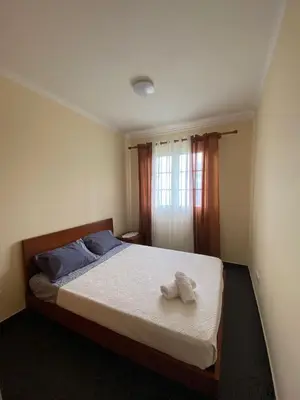 a bedroom with a bed with two towels on it at Ocean Guest House in São Vicente