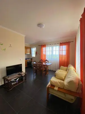 a living room with a couch and a table at Ocean Guest House in São Vicente