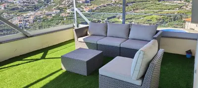 a balcony with two chairs and a bench and a view at Paraíso Pico da Torre in Câmara de Lobos