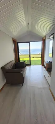 a large living room with a couch and a large window at Paraíso Pico da Torre in Câmara de Lobos
