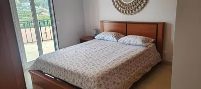 a bedroom with a bed with two pillows on it at Paraíso Pico da Torre in Câmara de Lobos