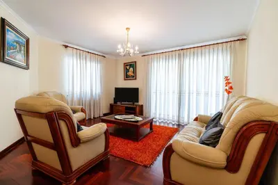 a living room with two chairs and a television at Vila do Conde Nº1 in Ribeira Brava