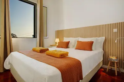 a bedroom with a large bed with two towels on it at Casa do Loureiro in Funchal