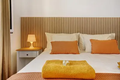 a bedroom with a bed with a teddy bear on it at Casa do Loureiro in Funchal