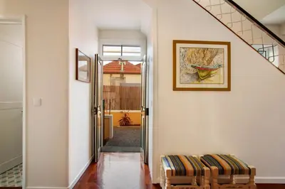 a hallway with two chairs and a picture on the wall at Casa do Loureiro in Funchal