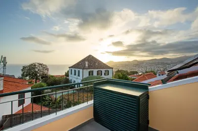 a balcony with a view of the ocean at Casa do Loureiro in Funchal