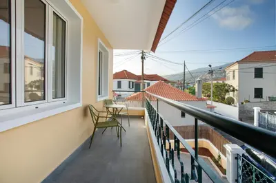 a balcony with a table and chairs on it at Casa do Loureiro in Funchal