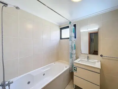 a bedroom with a yellow bed and a mirror at Agostinho Apartment by Atlantic Holiday in Santa Cruz