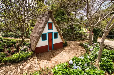 a small house with a turf roof in a garden at Agostinho Apartment by Atlantic Holiday in Santa Cruz