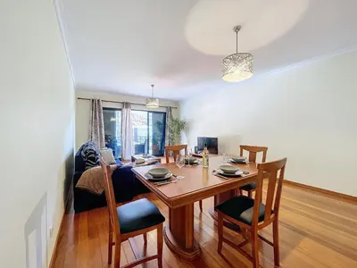 a dining room and living room with a table and chairs at Agostinho Apartment by Atlantic Holiday in Santa Cruz