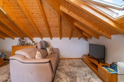 a living room with a couch and a tv at Salsa Country House I in Porto Moniz