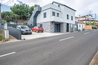 a white building on the side of a street at Salsa Country House I in Porto Moniz