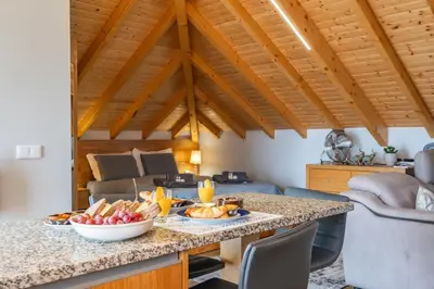 a kitchen and living room with a table with food on it at Salsa Country House I in Porto Moniz