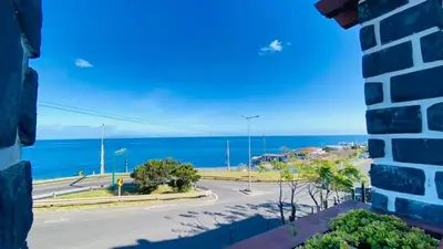 a view of the ocean from a building at Só Espeto Accommodation Rooms in Santa Cruz