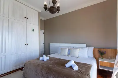 a bedroom with a bed with two towels on it at Só Espeto Accommodation Rooms in Santa Cruz