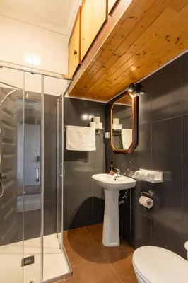 a bathroom with a sink and a shower at Só Espeto Accommodation Rooms in Santa Cruz