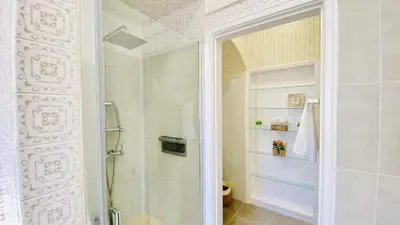 a bathroom with a shower and a glass door at Só Espeto Accommodation Rooms in Santa Cruz