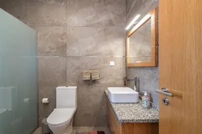 a bathroom with a toilet and a sink and a mirror at Salsa Country House II in Porto Moniz