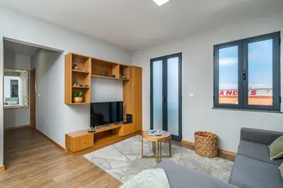 a living room with a couch and a tv at Salsa Country House II in Porto Moniz