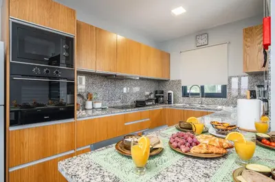 a kitchen with a table with plates of food on it at Salsa Country House II in Porto Moniz