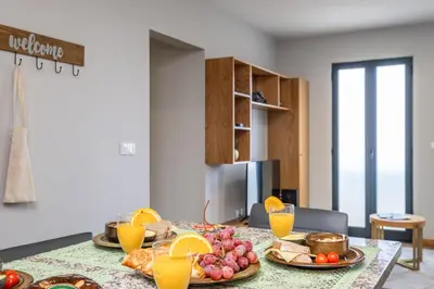 a table with plates of food and oranges on it at Salsa Country House II in Porto Moniz