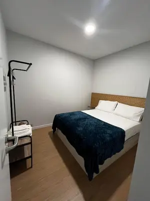 a bedroom with a bed with a blue blanket at Anastacio Tiny House in Porto Moniz