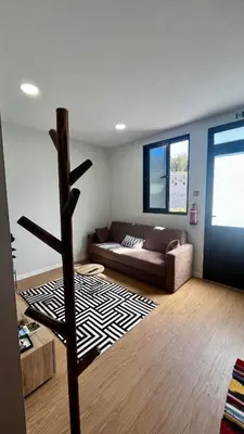 a living room with a couch and a rug at Anastacio Tiny House in Porto Moniz