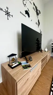 a flat screen tv sitting on top of a wooden entertainment center at Anastacio Tiny House in Porto Moniz