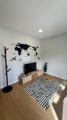 a living room with a map of the world on the wall at Anastacio Tiny House in Porto Moniz
