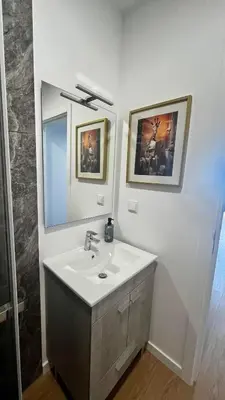 a bathroom with a sink and a mirror at Anastacio Tiny House in Porto Moniz