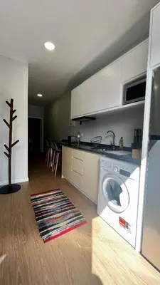 a kitchen with a washing machine in a room at Anastacio Tiny House in Porto Moniz