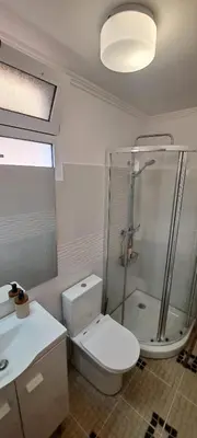 a bathroom with a toilet and a shower and a sink at Cozy Studio - Chalé Seixal in Seixal