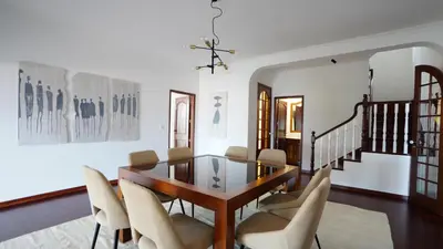 a dining room with a glass table and chairs at NostraCasa by LovelyStay in Caniço