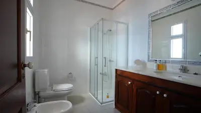a bathroom with a toilet sink and a shower at NostraCasa by LovelyStay in Caniço