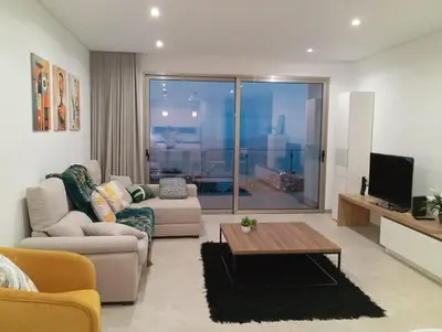 a living room with a couch and a table at Holiday House Caetano in Ponta do Sol
