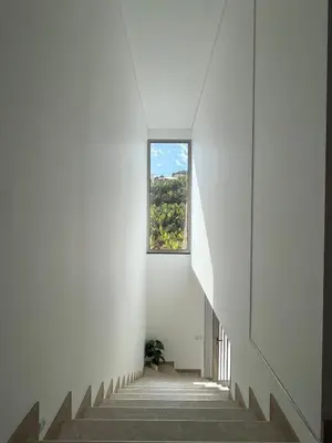 a staircase with a window in a white building at Holiday House Caetano in Ponta do Sol