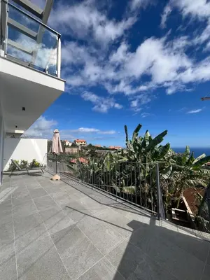 a balcony of a house with a view of the ocean at Holiday House Caetano in Ponta do Sol