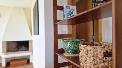 a room with a shelf with a vase and a fireplace at Garden of Eden by LovelyStay in Ponta Delgada