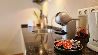 a counter top with a plate of food next to a mixer at Garden of Eden by LovelyStay in Ponta Delgada
