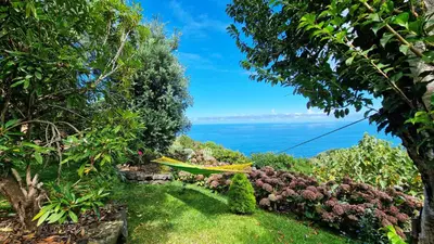 a view of the ocean from a garden at Garden of Eden by LovelyStay in Ponta Delgada