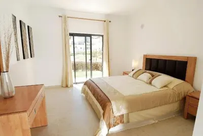 a bedroom with a large bed and a large window at Casa Ella in Lagos