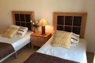 a bedroom with two beds and a lamp on a night stand at Casa Ella in Lagos